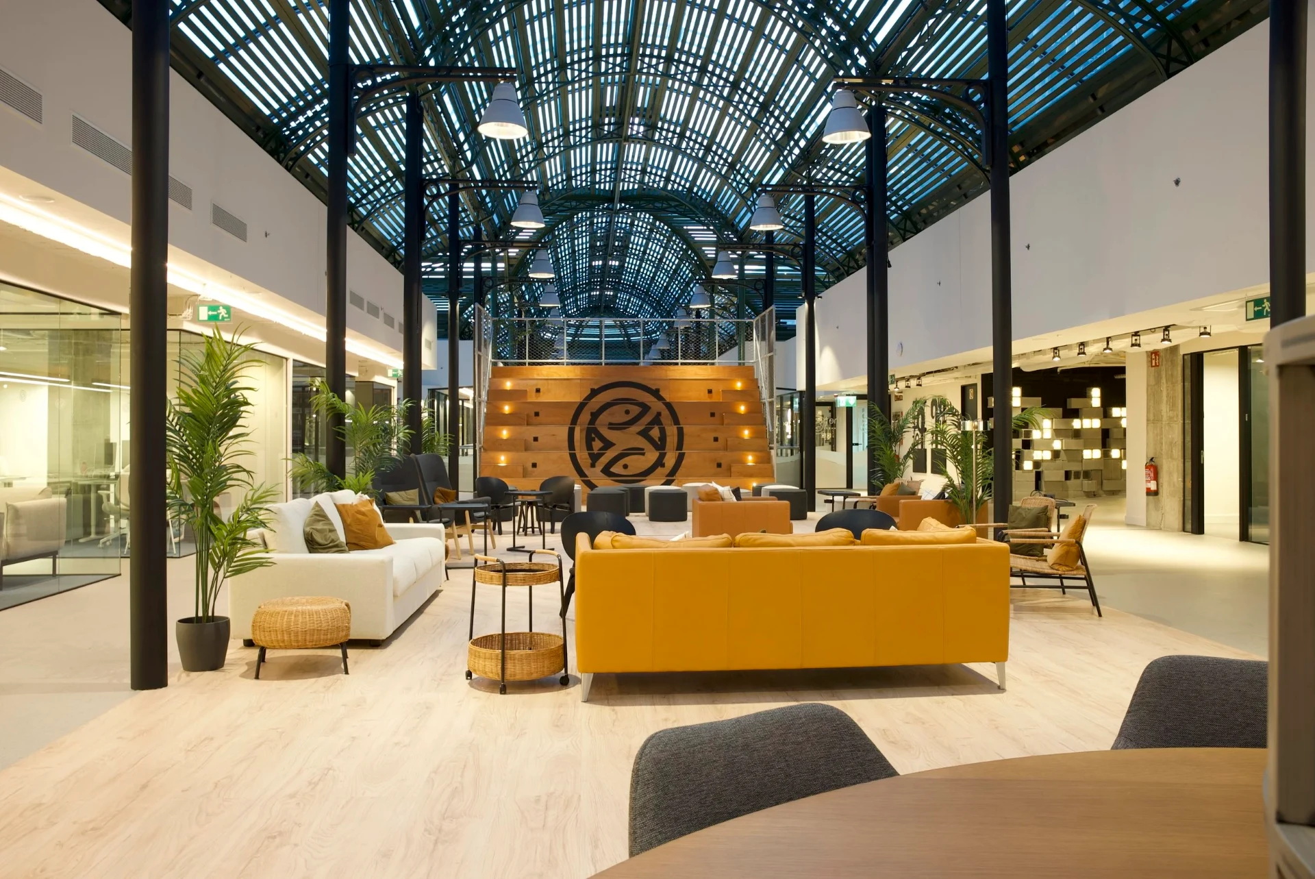 The Pool Marbella, a restored industrial hall with lounge seating under a vaulted glass roof